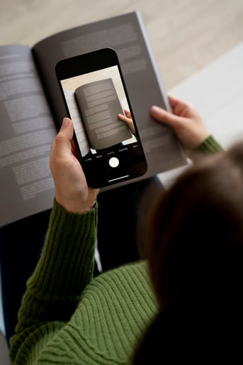 woman-taking-pictures-magazine-using-her-smartphone